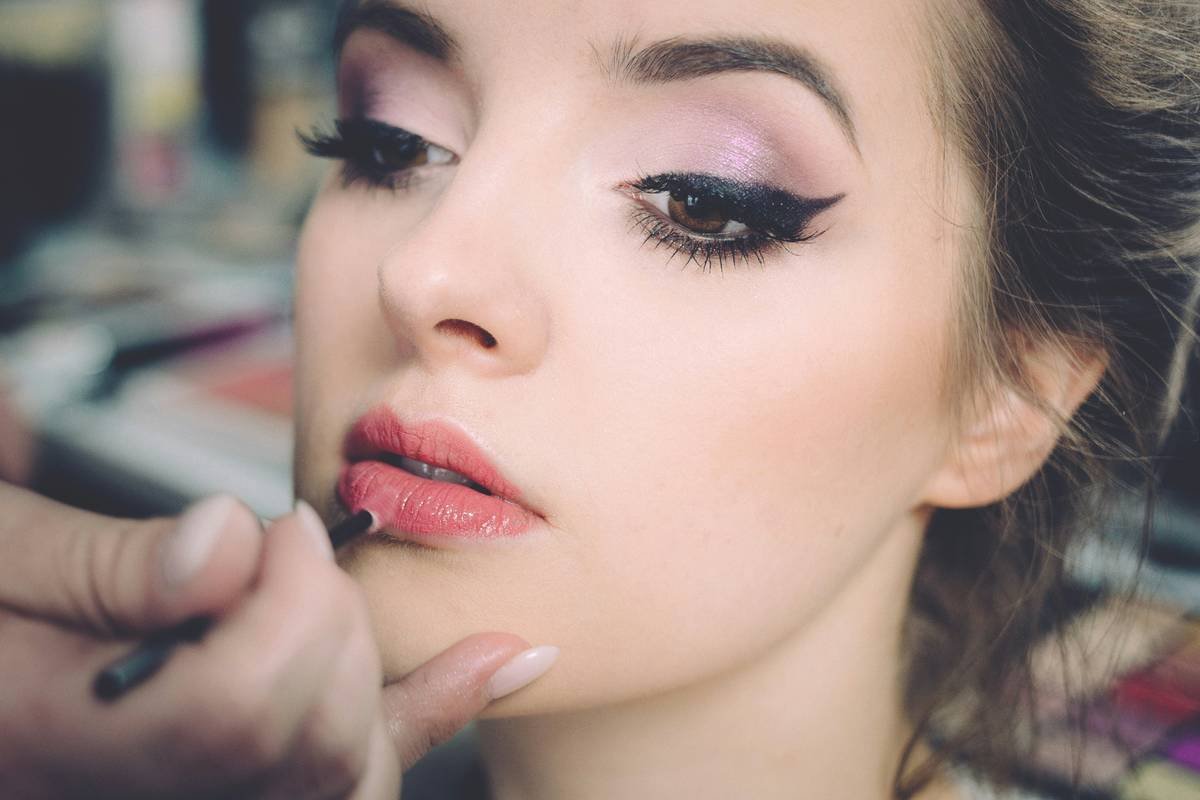 Side-by-side comparison: beauty queen makeup under natural light vs. stage lighting showing faded blush and shifted undertones