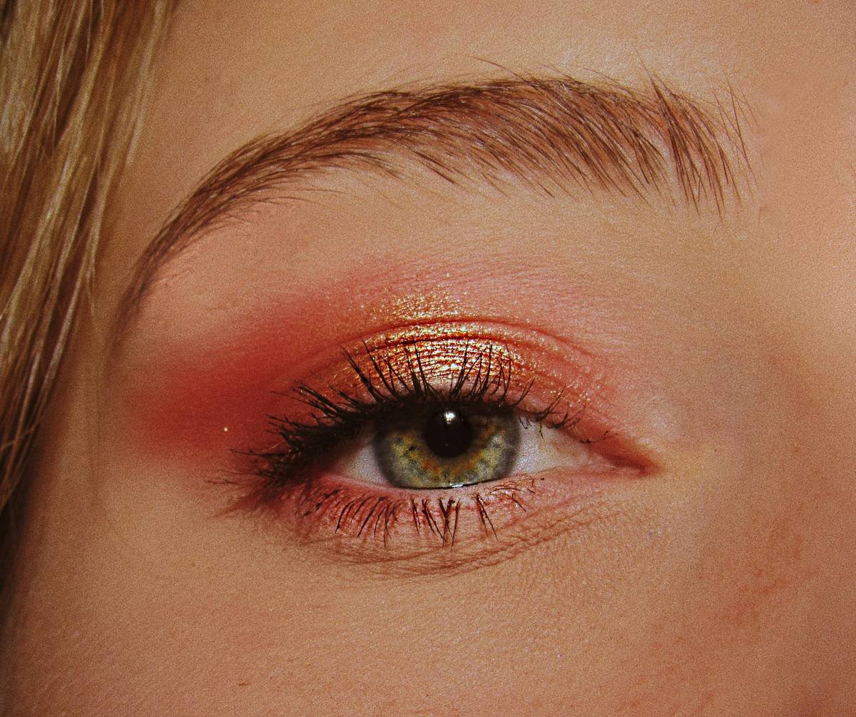 Side-by-side comparison: same model wearing everyday makeup vs. stage-optimized pageant makeup under professional spotlights. Left side appears flat and washed out; right shows defined cheekbones, bold brows, and strategic shimmer.