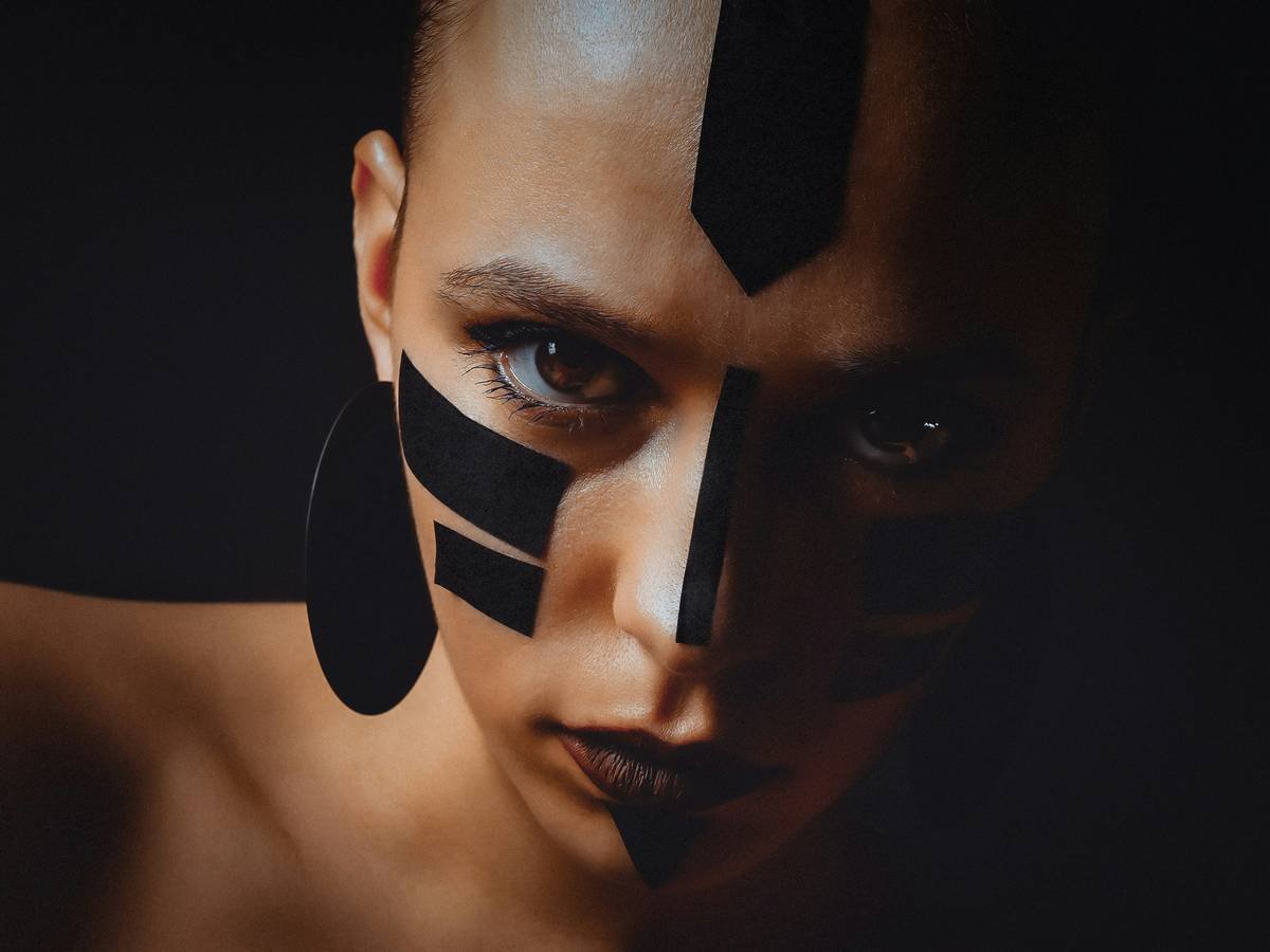 Close-up of award-winning fantasy makeup ideas featuring hand-sculpted facial prosthetics and iridescent paint