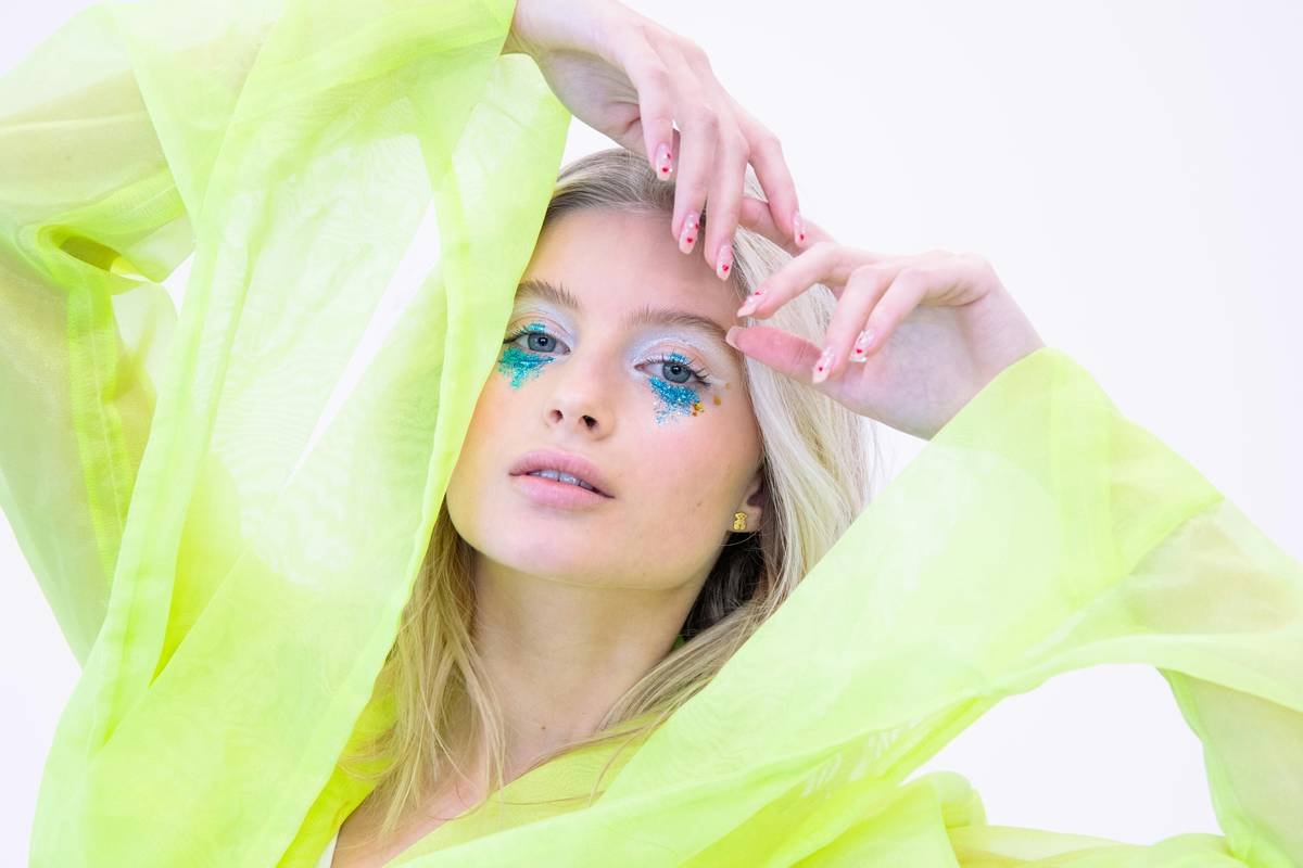Close-up of artist executing a timed makeup skill challenges with professional lighting setup
