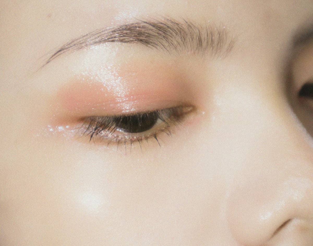 Artist applying hybrid materials for creative makeup trends competition